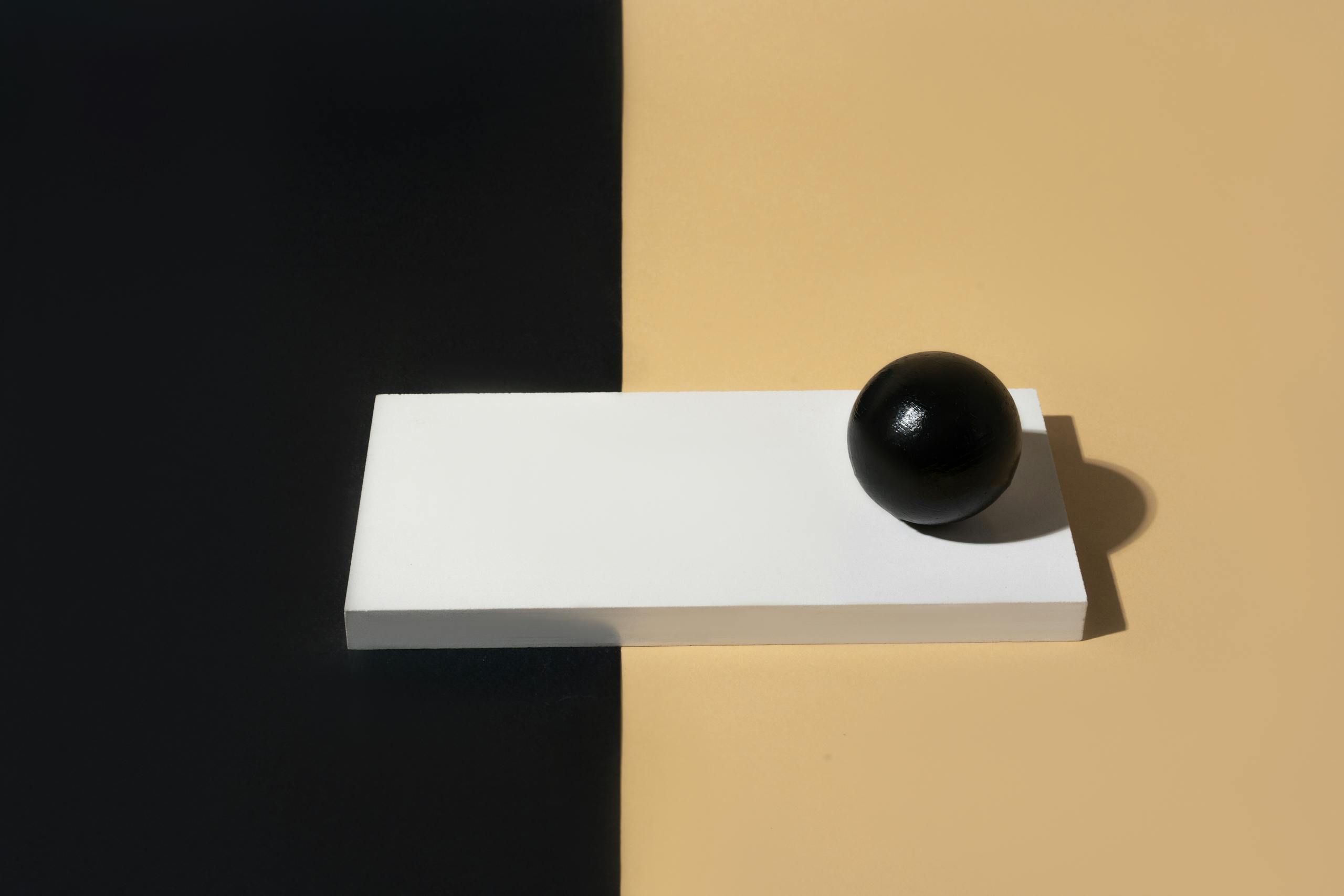 Artistic minimalist composition featuring geometric shapes and strong contrasts.